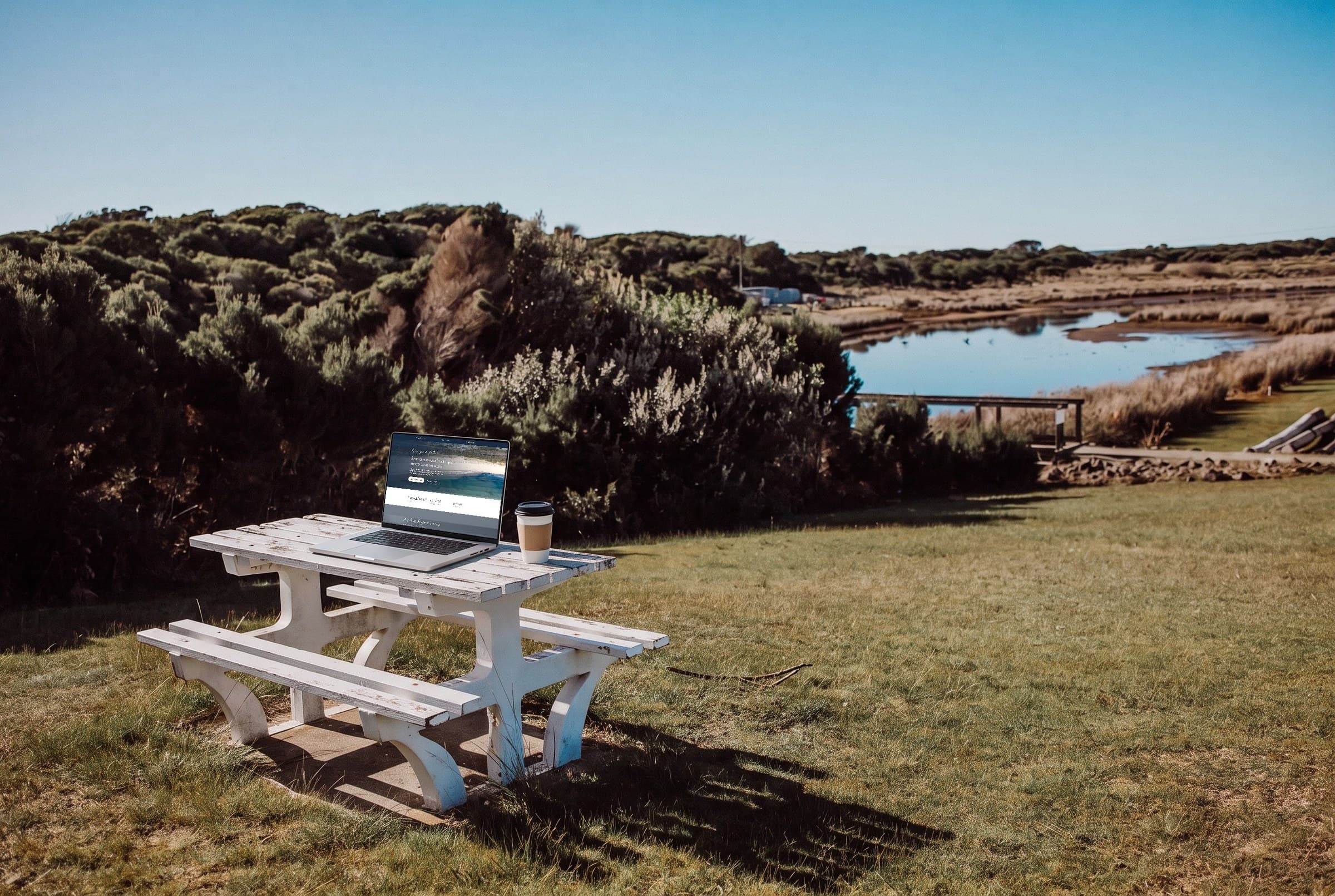 The site on a laptop, on the picnic table by the lagoon